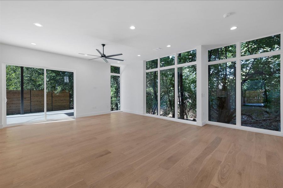 Unfurnished living room with recessed lighting, light wood finished floors, and a ceiling fan Unfurnished living room with recessed lighting, light wood finished floors, and a ceiling fan