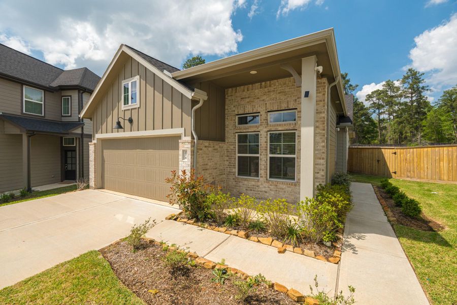 Front exterior of a new home in The Woodlands Hills, Willis, TX, highlighting curb appeal (Image 21).