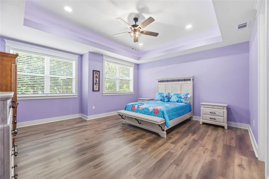 Thoughtfully designed bedroom featuring elegant tray ceilings and a calm contemporary aesthetic.