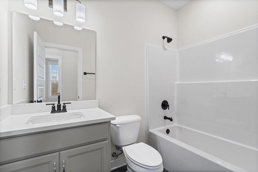 Full bathroom featuring shower / bath combination and vanity Full bathroom featuring shower / bath combination and vanity