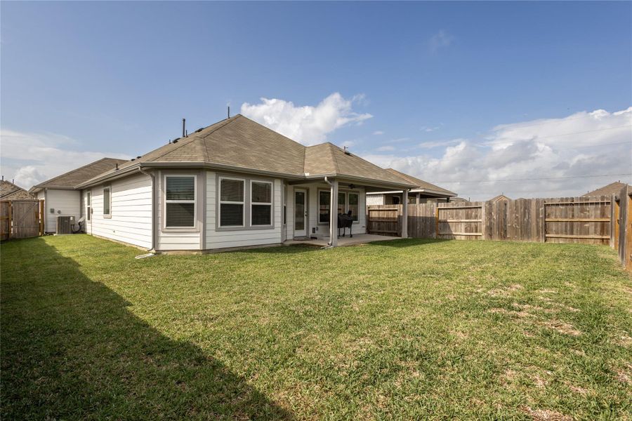 Exterior details and patio area of a home in Pinewood at Grand Texas, New Caney (Image 24).