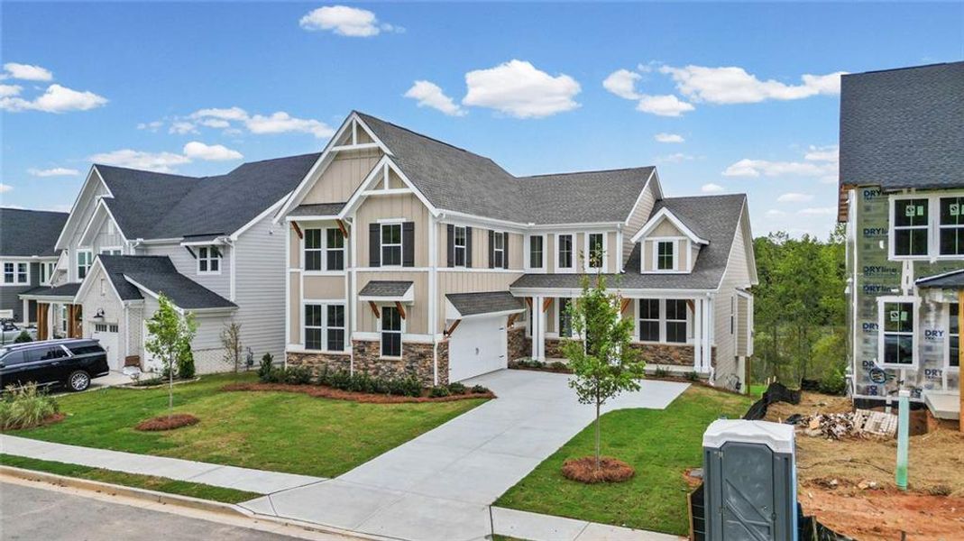 Front exterior of a new home in Twin Lakes, Hoschton, GA, highlighting curb appeal (Image 17). Front exterior of a new home in Twin Lakes, Hoschton, GA, highlighting curb appeal (Image 17).