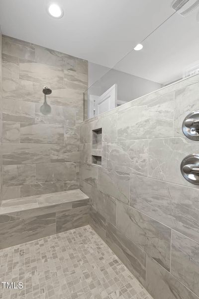Main Bath tiled with built-in bench