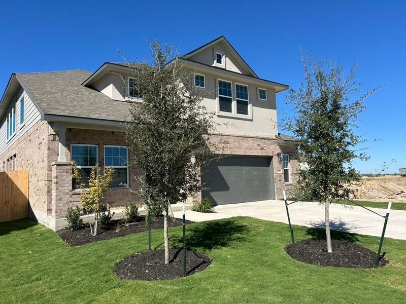 View of front of home featuring brick siding, concrete driveway, an attached garage, and roof with shingles View of front of home featuring brick siding, concrete driveway, an attached garage, and roof with shingles