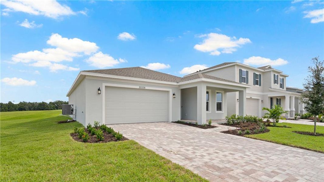 Front exterior of a new home in Trailside, Mount Dora, FL, highlighting curb appeal (Image 2).