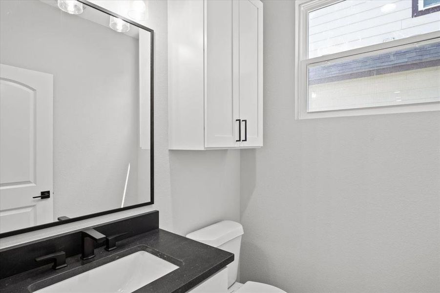 Half bath featuring toilet and vanity