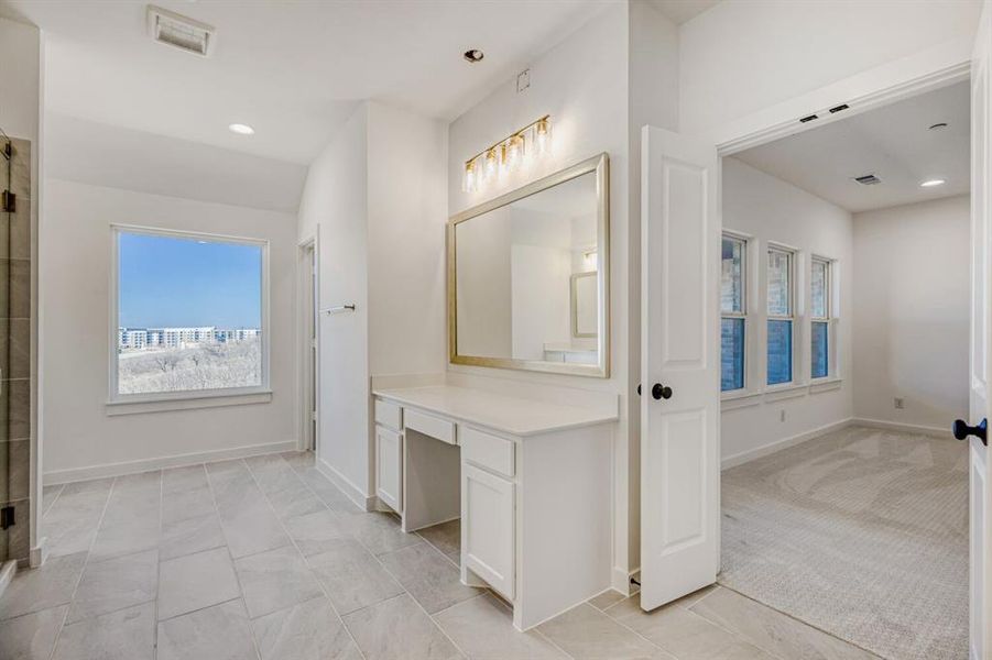 Full bath with recessed lighting, vanity, a shower stall, and light tile patterned floors