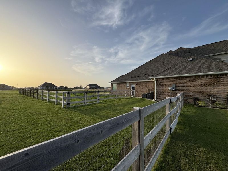Fenced dog run connected to side garage entry
