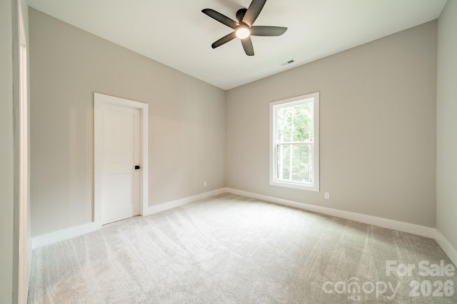 Spacious Bedroom 2 on the Main Level with a Walk-in Closet overlooking Lake Norman