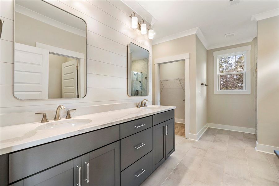 This bathroom features a sleek vanity, bathtub, an