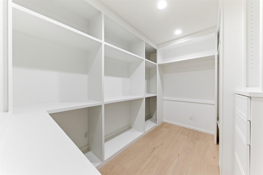 This spacious walk-in closet offers abundant storage and thoughtful organization with room for every wardrobe essential.