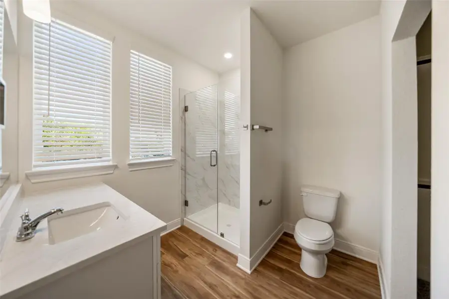 En-suite bath with seamless shower.