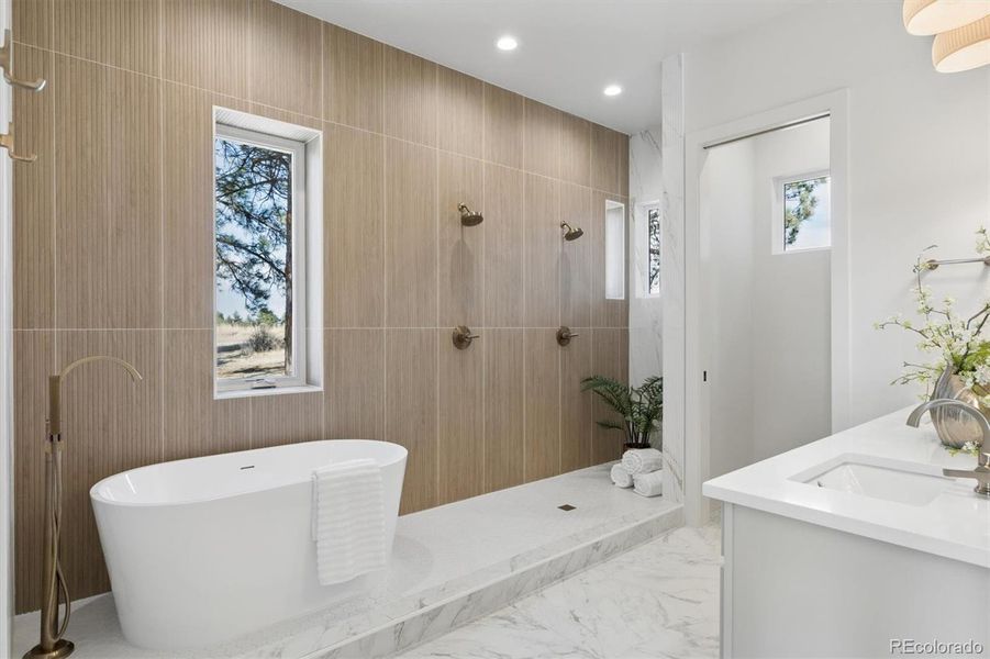 Gorgeous primary bath w/dual vanities, dual shower heads & all custom tile