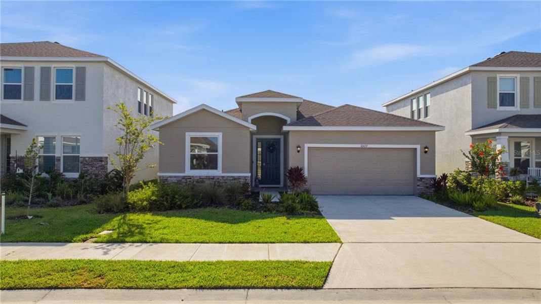 Front exterior of a new home in Bella Lago, Parrish, FL, highlighting curb appeal (Image 23). Front exterior of a new home in Bella Lago, Parrish, FL, highlighting curb appeal (Image 23).