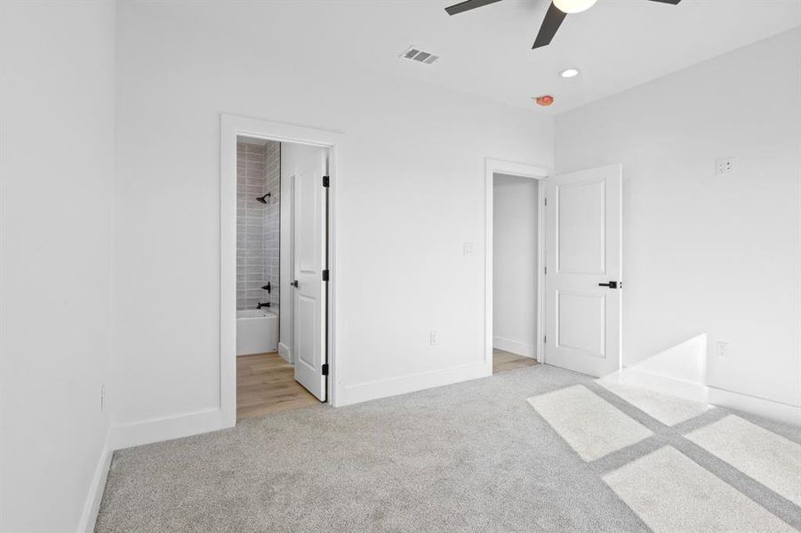 Unfurnished bedroom featuring visible vents, baseboards, carpet floors, recessed lighting, and ensuite bath Unfurnished bedroom featuring visible vents, baseboards, carpet floors, recessed lighting, and ensuite bath