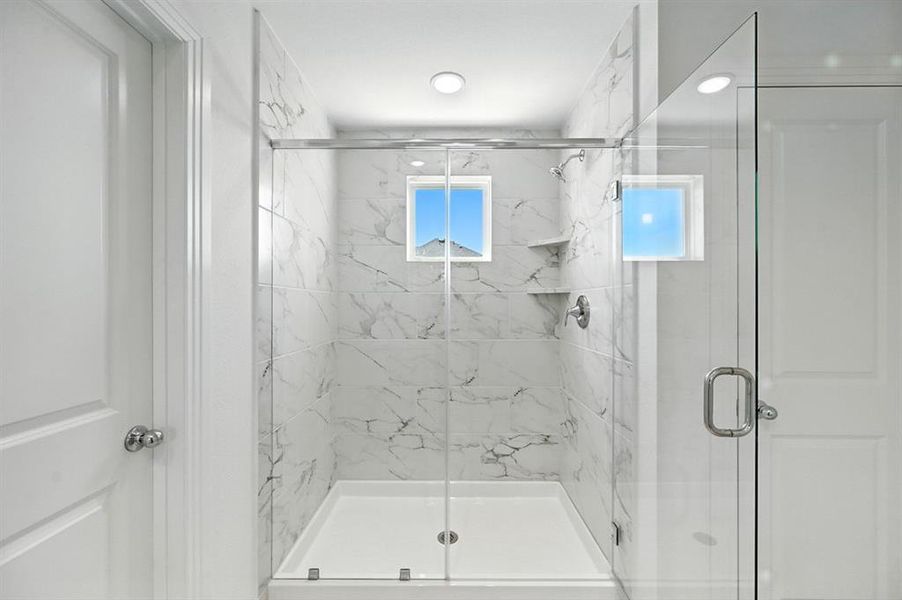 Bathroom featuring a marble finish shower