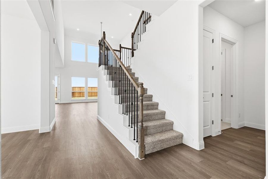 Stairway featuring wood finished floors and recessed lighting Stairway featuring wood finished floors and recessed lighting