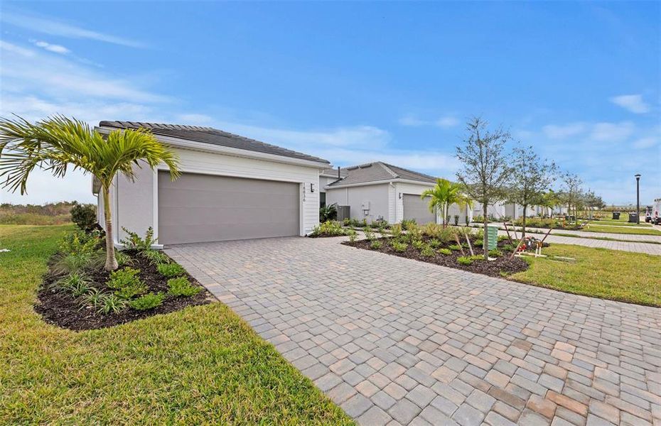 Front exterior of a new home in Del Webb Catalina, Lakewood Ranch, FL, highlighting curb appeal (Image 2). Front exterior of a new home in Del Webb Catalina, Lakewood Ranch, FL, highlighting curb appeal (Image 2).