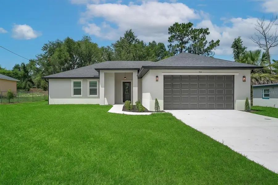 Front exterior of a new home in , Orange City, FL, highlighting curb appeal (Image 1). Front exterior of a new home in , Orange City, FL, highlighting curb appeal (Image 1).