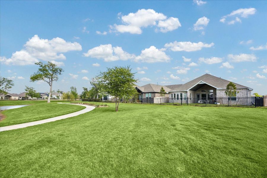 Impressive rear view of the home, highlighting the expansive 8,870 SF lot and its prime position along the community greenbelt. Enjoy the peace and quiet of having no back neighbors, with easy access to scenic walking trails and stunning sunset views right from your backyard. Impressive rear view of the home, highlighting the expansive 8,870 SF lot and its prime position along the community greenbelt. Enjoy the peace and quiet of having no back neighbors, with easy access to scenic walking trails and stunning sunset views right from your backyard.