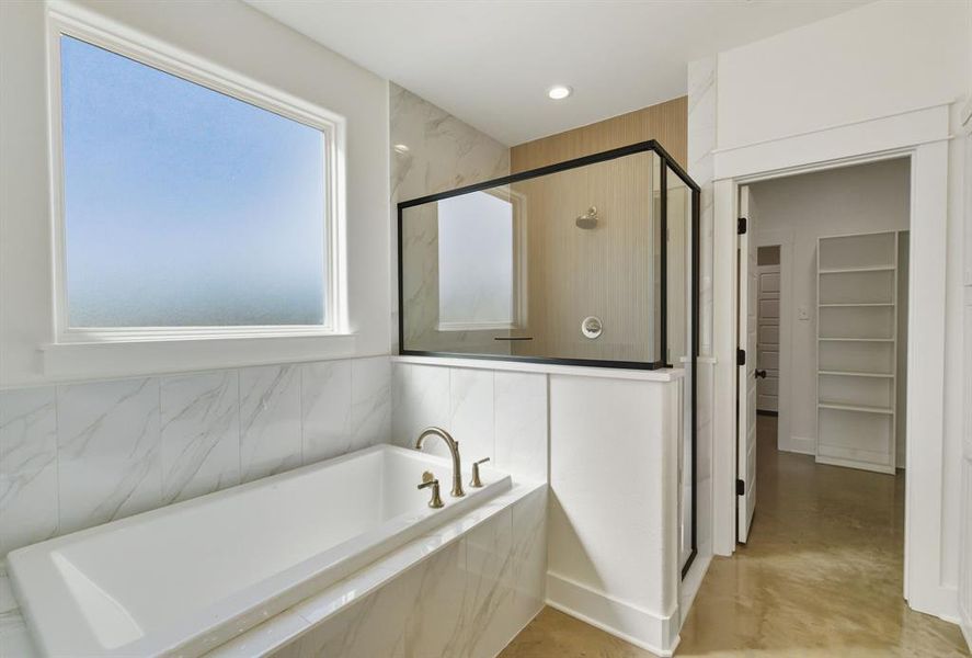 Bathroom with a marble finish shower, a spacious closet, a bath, finished concrete floors, and recessed lighting