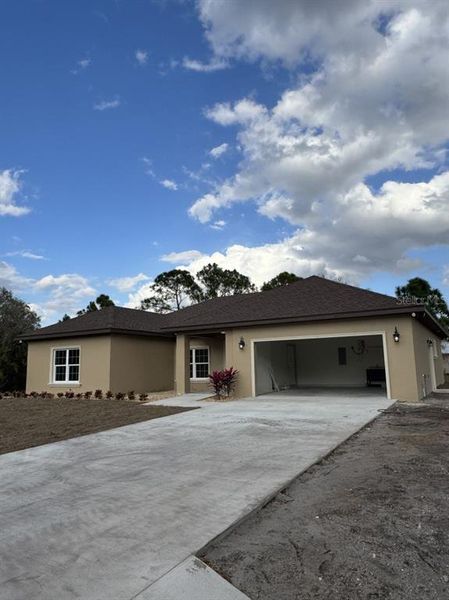 Front exterior of a new home in , Okeechobee, FL, highlighting curb appeal (Image 1). Front exterior of a new home in , Okeechobee, FL, highlighting curb appeal (Image 1).
