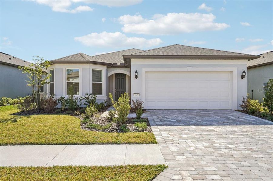 Front exterior of a new home in Del Webb Stone Creek, Ocala, FL, highlighting curb appeal (Image 1).