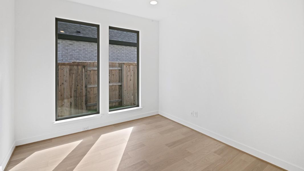 Empty room featuring wood finished floors and recessed lighting