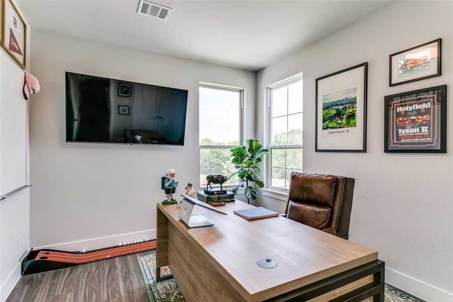 Home office featuring hardwood / wood-style floors and a healthy amount of sunlight