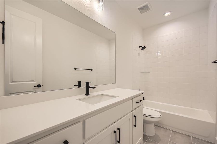 Full bath with vanity, toilet, recessed lighting, shower / tub combination, and tile patterned flooring