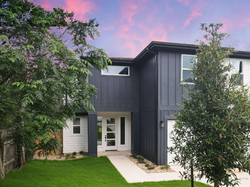 A striking modern facade with clean lines and a welcoming entry path under a vibrant sky. A striking modern facade with clean lines and a welcoming entry path under a vibrant sky.