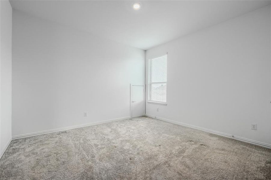 Carpeted empty room featuring baseboards Carpeted empty room featuring baseboards