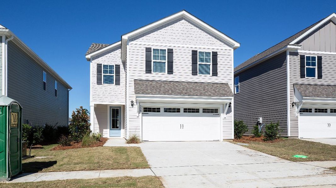 Front exterior of a new home in Indigo Preserve, Leland, NC, highlighting curb appeal (Image 1). Front exterior of a new home in Indigo Preserve, Leland, NC, highlighting curb appeal (Image 1).