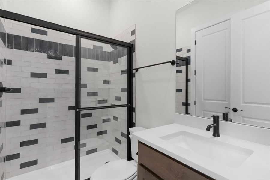 Full bath with vanity and a shower stall