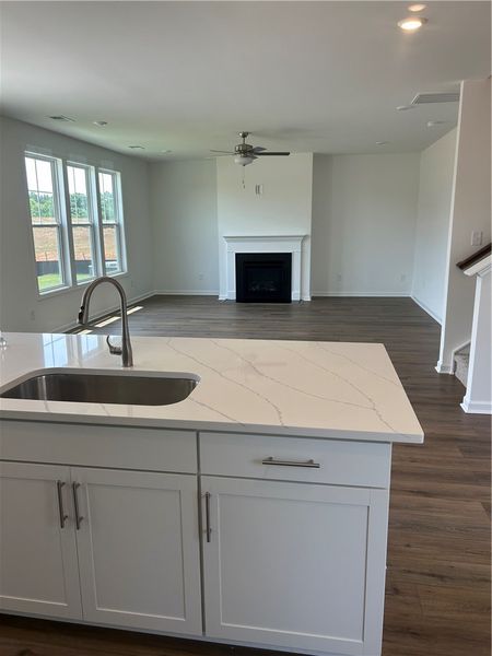 An open concept living area boasts a sleek kitchen