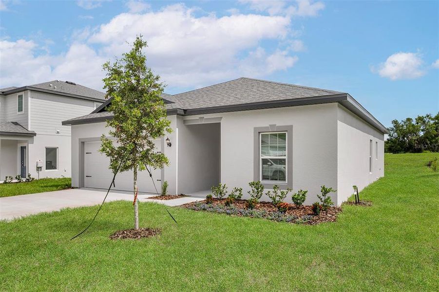 Front exterior of a new home in Tula Parc, Astatula, FL, highlighting curb appeal (Image 1).