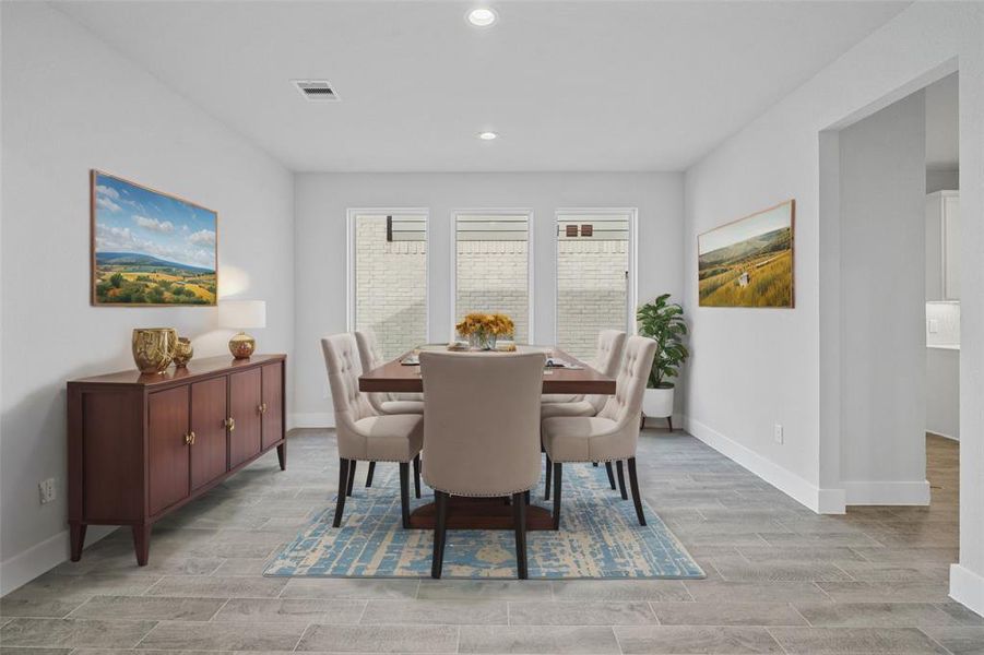 Make memories gathered around the table with your family and friends! This dining room features high ceilings, custom paint, recessed lighting, and large windows with privacy blinds.