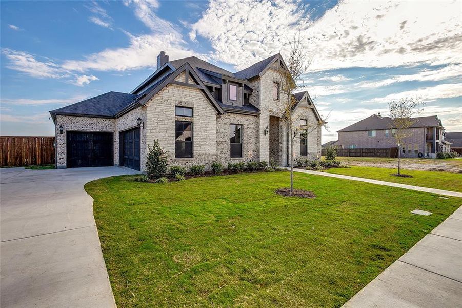 View of front facade with a front yard and a garage