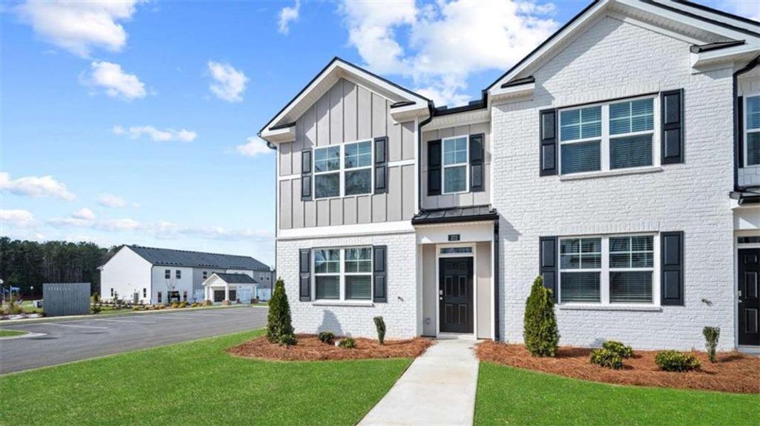 Front exterior of a new home in Echo Glen, Stockbridge, GA, highlighting curb appeal (Image 2). Front exterior of a new home in Echo Glen, Stockbridge, GA, highlighting curb appeal (Image 2).