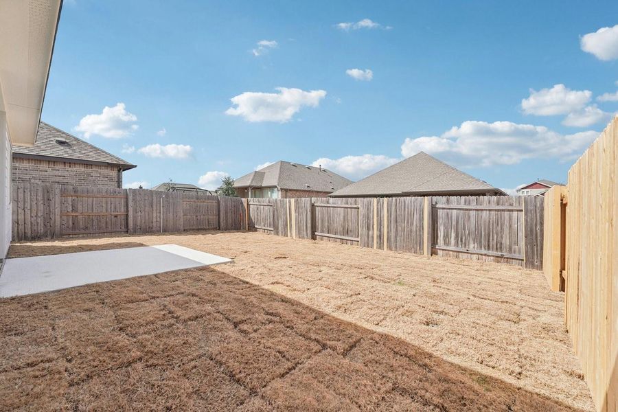 A spacious, enclosed backyard offers a private retreat with ample room for outdoor activities. A spacious, enclosed backyard offers a private retreat with ample room for outdoor activities.