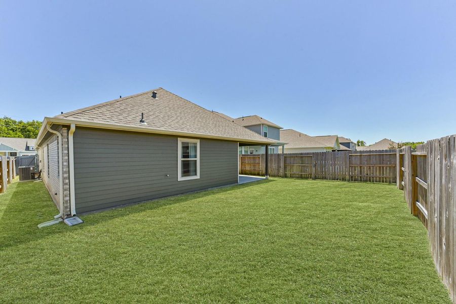 Take note of the fully fenced backyard, offering privacy and security, along with gutters installed along the exterior of the home for added protection from elements. Take note of the fully fenced backyard, offering privacy and security, along with gutters installed along the exterior of the home for added protection from elements.