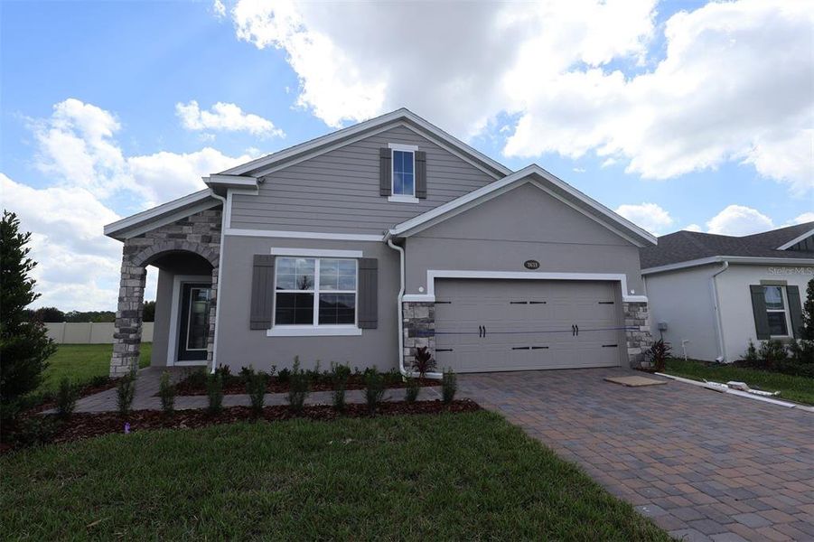 Front exterior of a new home in Bay Lake Farms, St. Cloud, FL, highlighting curb appeal (Image 1).
