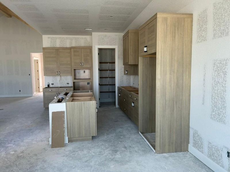 Kitchen with a center island and concrete floors Kitchen with a center island and concrete floors