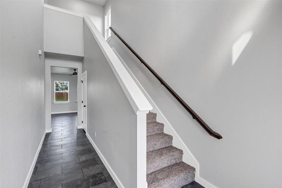 Stairway with baseboards and ceiling fan