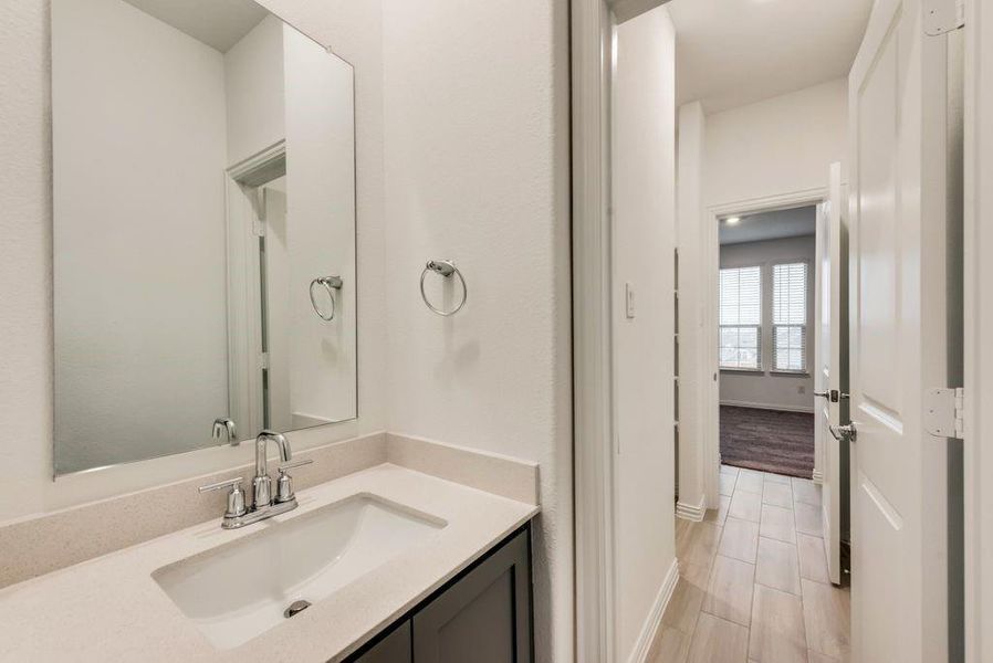 Bathroom featuring hardwood / wood-style flooring and vanity