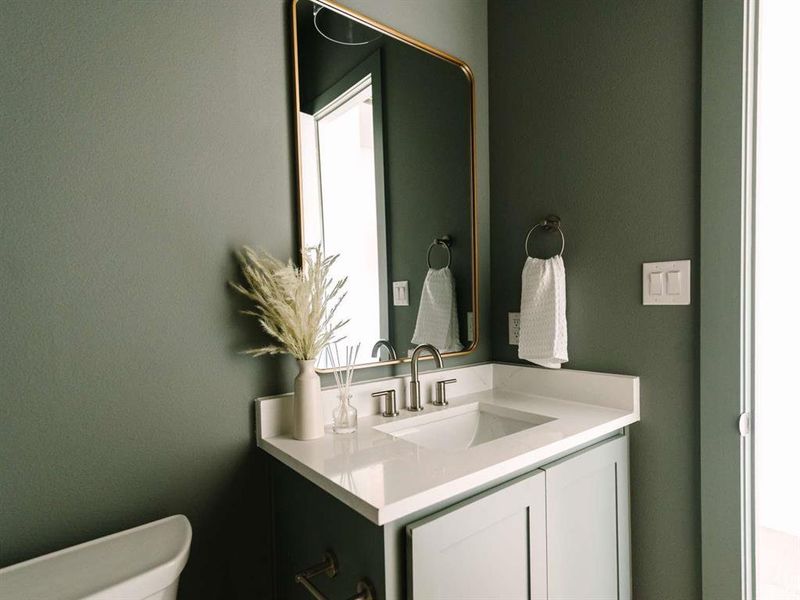 Bathroom featuring vanity and toilet