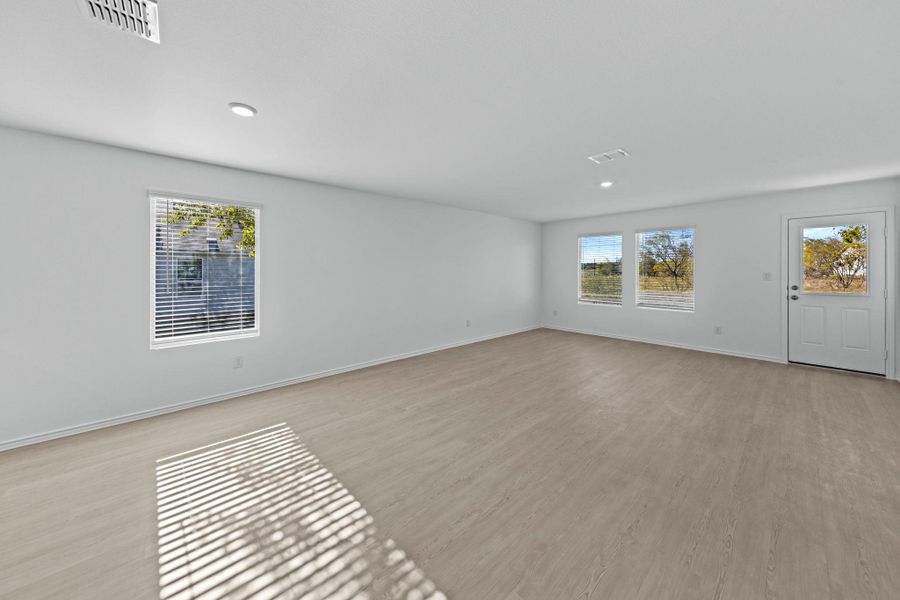 Empty room featuring light wood finished floors and recessed lighting Empty room featuring light wood finished floors and recessed lighting