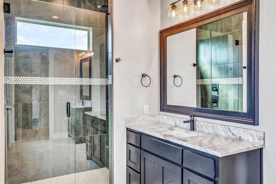 Bathroom featuring vanity and walk in shower