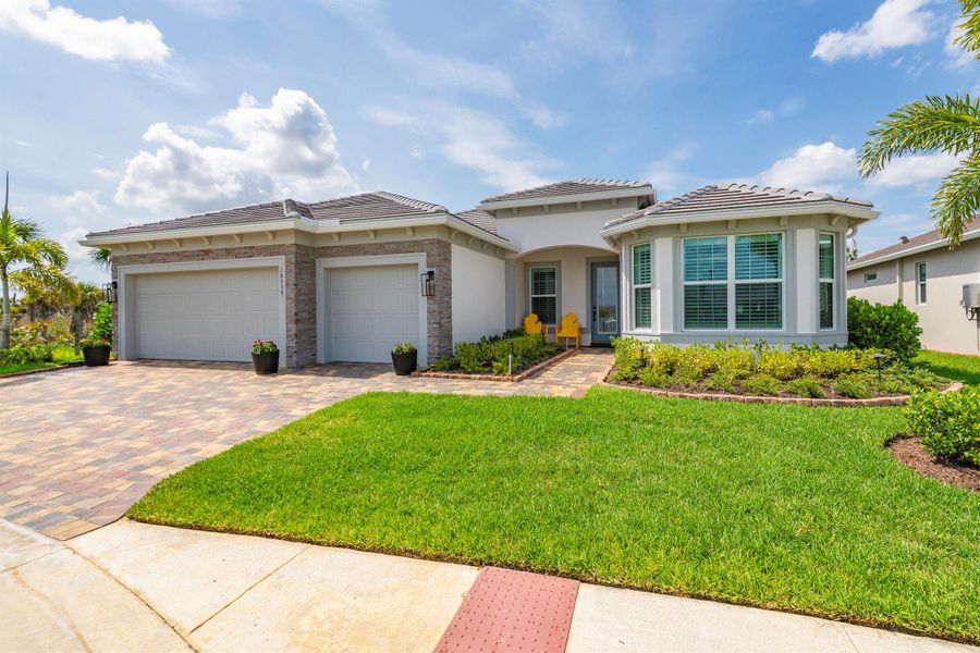 Front exterior of a new home in Del Webb Tradition, Port St. Lucie, FL, highlighting curb appeal (Image 2). Front exterior of a new home in Del Webb Tradition, Port St. Lucie, FL, highlighting curb appeal (Image 2).