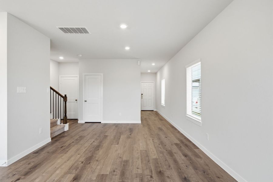 A long hallway with white doors. A long hallway with white doors.